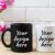 Black Coffee Mug and White Cappuccino Cup Mockup with Pink Tulips