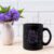Black Coffee Mug Mockup with Blue Ageratum in Pitcher