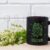 Black Coffee Mug Mockup with White Spiraea Flowers