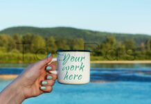 Woman Holding Enamel Mug with River View Poster 1